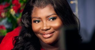 Stunning portrait of a smiling woman in a red dress with floral background.