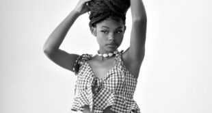 Artistic black and white portrait of a woman balancing a pineapple, showcasing elegance.