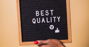 Hands holding a letter board with 'Best Quality' text, emoji, and thumbs up.