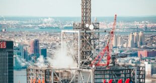 A stunning aerial shot of a New York City skyscraper featuring prominent H&M branding against the cityscape backdrop.