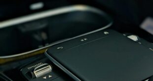 Detailed image of a sleek modern car control panel with touchpad and control buttons.