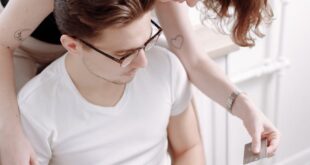 Young couple using a laptop for online shopping together, focused on credit card payment.