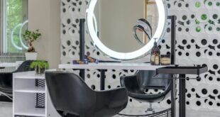 Chic salon setup featuring sleek chairs and illuminated vanity mirror.