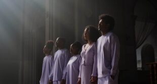 African American choir singing with sunbeams shining through church windows, creating a serene atmosphere.