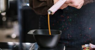 Stylist prepares hair dye at a beauty salon. Creative hair coloring process.