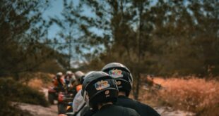 Group of people enjoying an ATV ride through a sandy path surrounded by nature.