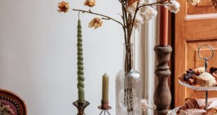 A beautifully arranged vintage high tea setup with floral decorations and pastries.