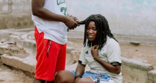 Two young adults in street fashion enjoying a casual moment outdoors.