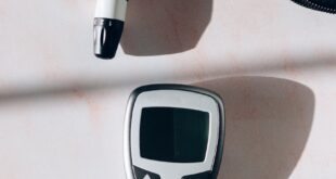 Close-up of a glucose meter and lancet for diabetes monitoring.