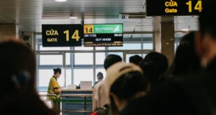 People standing in line at an airport gate, waiting to board a flight.