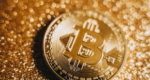 A macro shot of a bitcoin coin resting on a glittery gold surface, emphasizing wealth and digital currency.