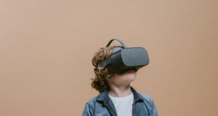 Young boy wearing VR headset, immersed in virtual reality experience indoors.
