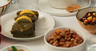 Close-up of diverse Mediterranean dishes and hands serving soup, perfect for home-cooking ideas.