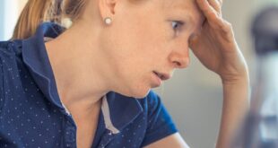 Businesswoman showing stress and concentration while working at her desk.