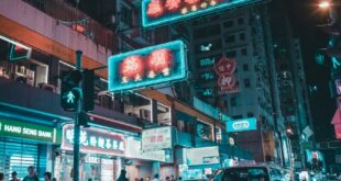 Explore the bustling nightlife of Kowloon, Hong Kong with neon lights and city life.