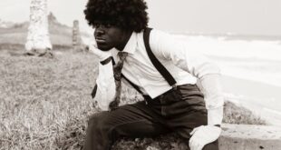 Vintage-inspired portrait of a man in Takoradi, blending classic attire with seaside serenity.