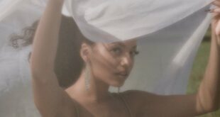 Soft focus portrait of woman outdoors with a veil, captured in a dreamy style.