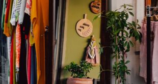 A quaint Turkish thrift store corner with vibrant clothing and rustic decor.