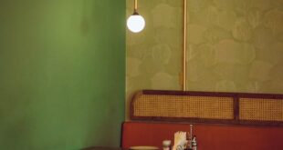 Warm, stylish restaurant interior with wooden furniture and soft lighting in Accra.