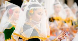 Beautiful Manipuri dancers in traditional attire performing Raas dance in Imphal, India. Captivating cultural display.