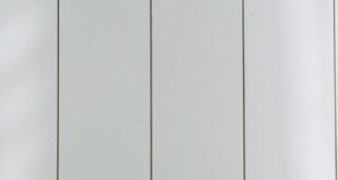 A sleek payment terminal with buttons against a white wooden background, ideal for finance concept.