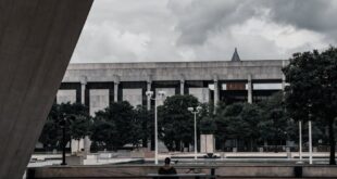 A moody architectural scene featuring Empire State Plaza in Albany, New York.