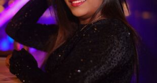 Woman in glittering black dress enjoying night out at a vibrant nightclub.