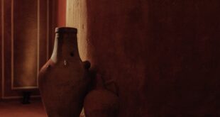 A serene display of ancient clay vases in a sunlit corner with warm, earthy tones.
