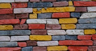 Vibrant close-up of a colorful brick wall showcasing texture and details.