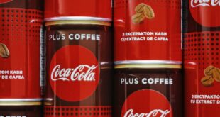 Close-up of Coca-Cola Plus Coffee cans featuring coffee extract, stacked in Kyiv.