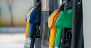 Close-up of vibrant fuel nozzles at a gasoline station showcasing diesel, gas, and petrol options.