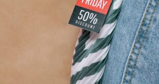 Close-up of Black Friday 50% discount tag on denim jeans, perfect for seasonal sales promotions.