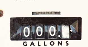 Close-up of an antique gas pump display showing zero sale and gallons with Tokheim branding.