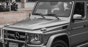 Stylish gray Mercedes G-Class SUV parked in modern urban setting.