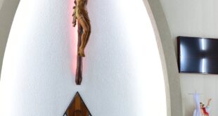 A serene church interior showcasing an altar with a crucifix and floral decoration, perfect for religious themes.