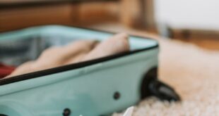 Open suitcase with travel documents and a toy plane, evoking a sense of adventure.