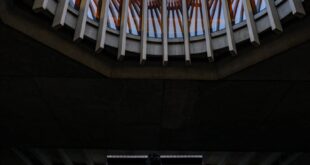 Person playing piano under a stunning skylight architecture at Simon Fraser University, Burnaby.