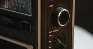Close-up of a vintage portable radio showcasing dials and tuning details, embodying retro design.