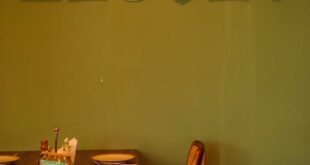 Warm and inviting restaurant interior in Accra with abstract wall art.