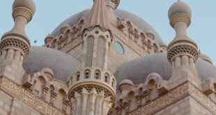 A beautifully detailed mosque with intricate Islamic architectural design captured at dusk.