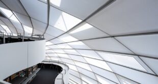 A modern library with a unique glass ceiling, ideal for students studying under natural light.