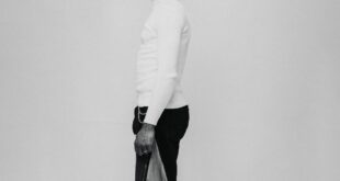Black and white studio portrait of a fashionable man wearing eyeglasses and a hat in Ghana.