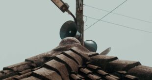 Low angle view of a rooftop with loudspeakers in Kumasi, Ghana.
