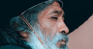 Portrait of an elderly man wearing a traditional Mexican sombrero and embroidered clothing.