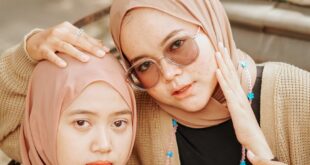 Two women wearing hijabs and sunglasses posing outdoors in Cirebon, Indonesia.