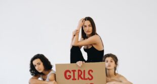 Three women advocating for gender equality with a Girls Power sign.