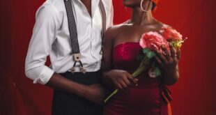 Stylish couple in a creative fashion portrait on a red backdrop, Kumasi, Ghana.