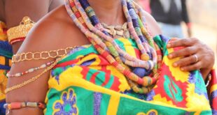 Portrait of a woman in colorful traditional attire during a cultural event in Accra, Ghana.