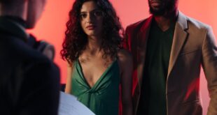 Actors rehearsing with a director in a studio setting, discussing the script and roles.