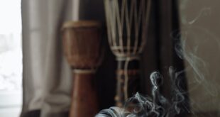 Aromatic incense burning on a woven mat with djembe drums, creating a soothing atmosphere.